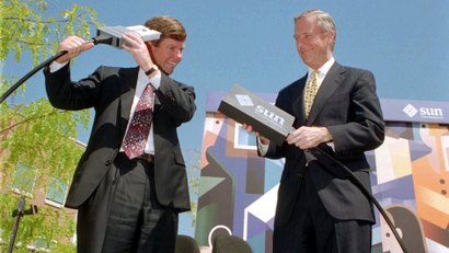 Sun Microsystems Inc. CEO Scott McNealy, left, jokes around with a fiber optic cable connection, during a news conference with Calif. Gov. Pete Wilson, right, at Sun Microsystem's Menlo Park, Calif. facility, Wednesday, Aug. 24, 1994. It has been reported that Sun Microsystems Inc. is preparing a bid for the financially struggling Apple Computers Inc. Sun's main focus is workstations and internet servers and an acquisition of Apple would give Sun access to the fast-growing market for desktop computers.