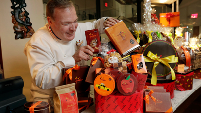 chef-jacques-torres puts the finishing touches on gift baskets.