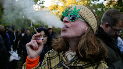 A woman smokes a joint on the day Canada legalizes recreational marijuana at Trinity Bellwoods Park, in Toronto, Ontario, Canada, October 17, 2018. REUTERS/Carlos Osorio - RC1C0A4A3990