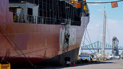 A crew member boards a cargo ship in in Montreal, Quebec in May 2021