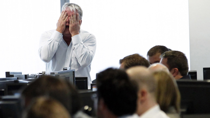 A broker reacts at BGC Partners at Canary Wharf financial district in London