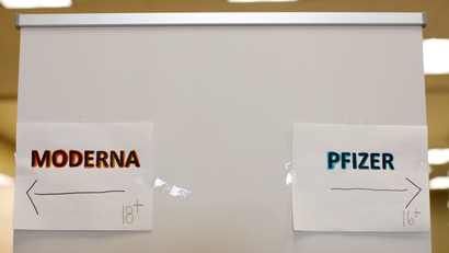 Signs and age groups are shown for the Pfizer and Moderna vaccines.