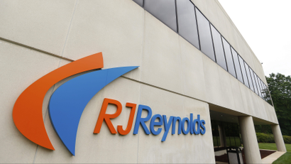 The blue and orange sign of tobacco maker RJ Reynolds outside their headquarters