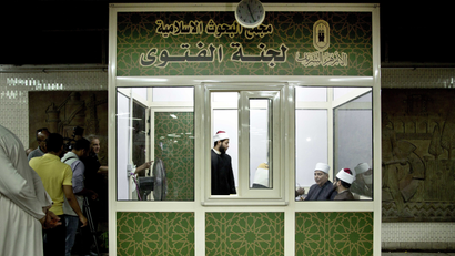 Al-Azhar clerics wait to answer commuters questions inside a Fatwa Kiosk, at the Al Shohada'a metro station, in Cairo, Egypt, Tuesday, July 25, 2017. Al-Azhar, the Sunni Muslim world's foremost religious institution, has set up booths in Cairo metro stations to provide religious edicts to commuters in the latest bid to dispel religious misconceptions seen as fostering Islamic militancy in the country, which is targeting mainly security personnel and Christians.