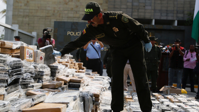 Colombia's police chief General Rodolfo Palomino examines confiscated packs of cocaine in Cartagena