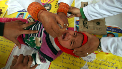 A child receives polio drops during a polio eradication programme in Jammu February 19, 2012. The polio eradication programme in India aims to immunize every child under five years of age with the oral polio vaccine.