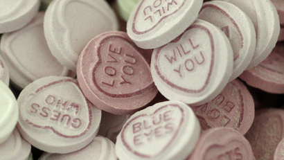 Love Hearts sweets wait to be sorted and packaged on the production line at the Swizzels-Matlow factory in New Mills northern England