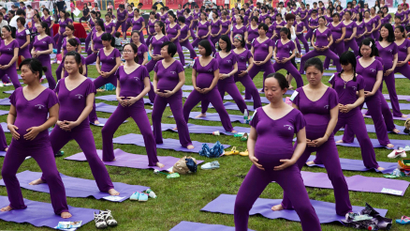 Pregnant women practice yoga as they attempt to break the Guinness World Record for the largest prenatal yoga class, in Changsha