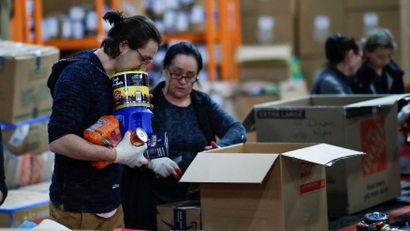 Workers packimg humanitarian aid donations in boxes to be shipped to Ukraine.