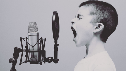 Kid screams into microphone