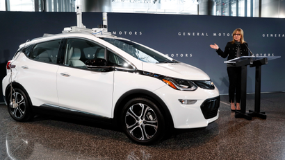 General Motors Chairman and Chief Executive Officer Mary Barra speaks next to a autonomous Chevrolet Bolt electric car Thursday, Dec. 15, 2016, in Detroit. General Motors has started testing fully autonomous vehicles on public roads around its technical center in suburban Detroit.