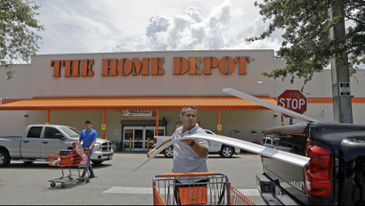 A man loads garage door trims into his pickup truck outside a Home Depot in Hialeah, Florida.