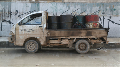 A pick-up truck carries fuel barrels for sale in the Aleppo countryside January 13, 2015.
