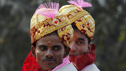 Grooms wearing traditional Indian bridal turbans attend their mass marriage ceremony at Noida