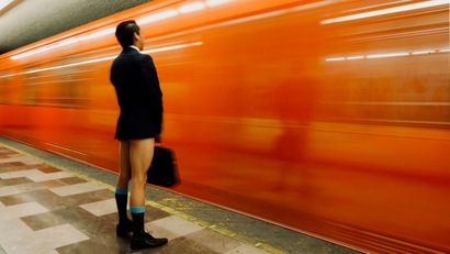 Man without pants waits for subway.