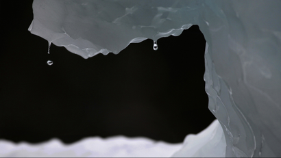 In this July 26, 2011 photo, drops of water fall from a melting iceberg near Nuuk, Greenland. Greenland is the focus of many researchers trying to determine how much its melting ice may raise sea levels. (AP Photo/Brennan Linsley