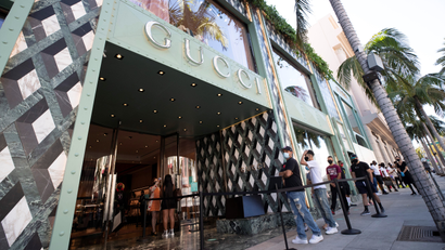 Shoppers stand in line wearing face masks outside the Gucci store during the outbreak of the coronavirus disease (COVID-19), in Beverly Hills, California