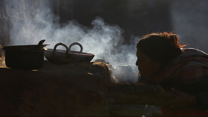 A woman uses firewood to cook food at Sapay, Achham in the Far-Western region of Nepal, around 900 km (559 miles) from Kathmandu February 17, 2014. REUTERS/Navesh Chitraka