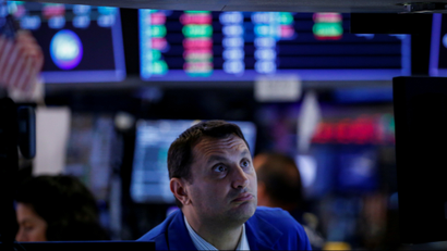 A trader works at his post on the floor of the New York Stock Exchange