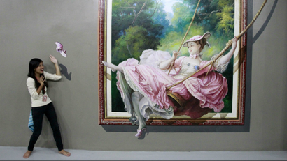 A student pose in front of a 3D painting during class field trip at the Art In Island Museum in Quezon...
