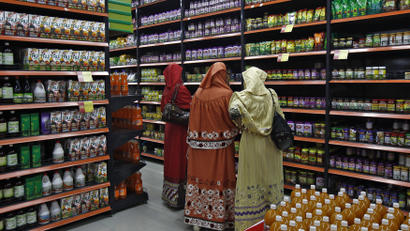 A photograph of people shopping in a grocery store