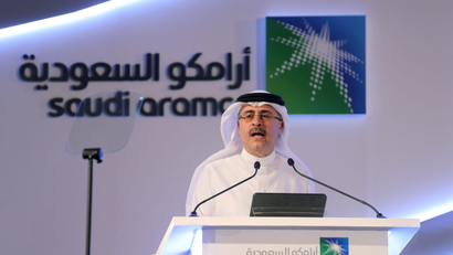 Aramco CEO Amin Nasser speaks from a podium during a news conference.