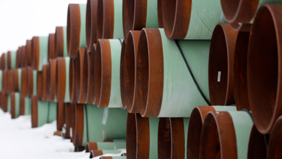 Dozens of bright green and leather brown pipes are stacked and piled in a depot for Transcanada Corps planned Keystone XL oil pipeline in North Dakota.