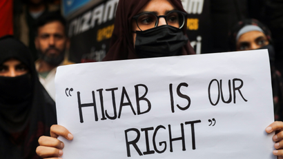 A Muslim woman holds a placard as she takes part in a protest organised by All India Majlis-e-Ittehadul Muslimeen (AIMM) against the recent hijab ban in few colleges of Karnataka state, at Shaheen Bagh in New Delhi