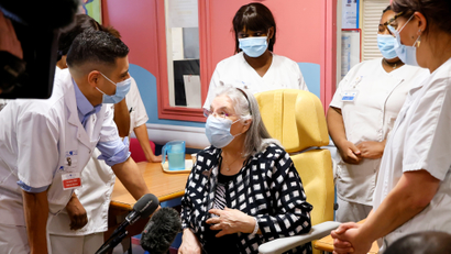 A 78-year-old French woman speaks with medical staff