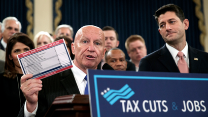 House Ways and Means Committee Chairman Kevin Brady, R-Texas, joined by Speaker of the House Paul Ryan, R-Wis., right, holds a proposed "postcard tax filing form" as they unveil the GOP's far-reaching tax overhaul, the first major revamp of the tax system in three decades, on Capitol Hill in Washington, Thursday, Nov. 2, 2017.