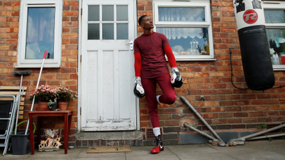 Boxer Shakan Peters poses during a training session in his mother's garden, following the outbreak of the coronavirus disease (COVID-19), UK