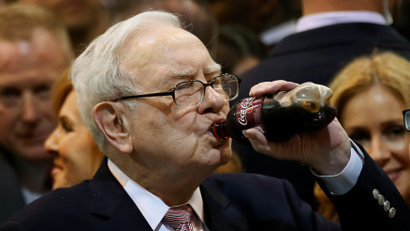 Berkshire Hathaway chairman and CEO Warren Buffett enjoys his favourite beverage, cherry Coke, before the Berkshire Hathaway annual meeting in Omaha