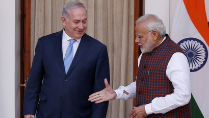 India's Prime Minister Modi extends his hand for a handshake with his Israeli counterpart Netanyahu during a photo opportunity ahead of their meeting at Hyderabad House in New Delhi
