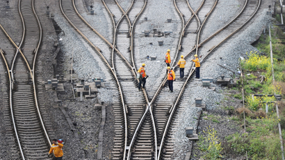 Workers inspect railway tracks, which serve as a part of the Belt and Road freight rail route linking Chongqing to Duisburg, at the Dazhou railway station