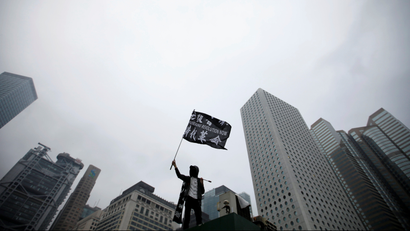 An anti-government protester waves a flag during a rally at Edinburgh Place in Hong Kong