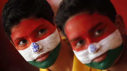 School boys with their faces painted in the colours of India's national flag, take part in India's Independence Day celebrations in Jammu