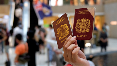 A pro-democracy demonstrator holds up a pair of British National Overseas (BNO) passports