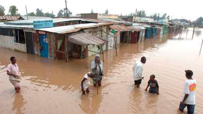 Villagers go about their business in a flooded market centre in Kisumu, about 400km west of the capital Nairobi in Kenya on Saturday 30 December 2006. Heavy rains continue to cause havoc in Kenya and parts of East Africa.