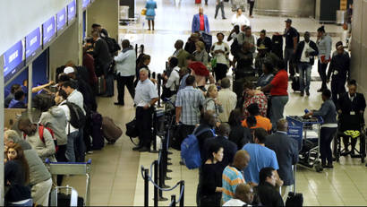 People queue at the South African Airways (SAA) ticket counter desk at OR Tambo International airport in Johannesburg, South Africa.