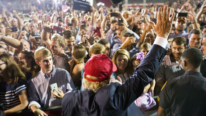 Donald Trump is pictured waving to a crowd in Mobile, Ala.