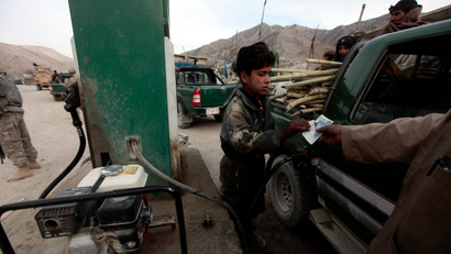 An Afghan employee fills a car with petrol at a gas station in the town of Saway-kowt in Khowst province, Afghanistan, December 26, 2009.