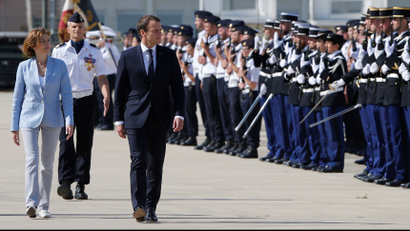 French President Emmanuel Macron reviews troops as he arrives at the military base in Istres
