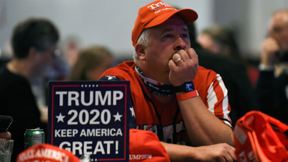 U.S. President Donald Trump supporter watches the 2020 U.S. presidential election results come in on Fox News at the DoubleTree Hotel in Bloomington, Minnesota, U.S.