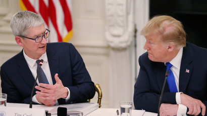 Apple CEO Tim Cook talks with U.S. President Donald Trump as they participate in an American Workforce Policy Advisory Board meeting in the White House State Dining Room in Washington, U.S., March 6, 2019.