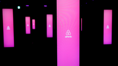 The logos of Airbnb are displayed at an Airbnb event in Tokyo