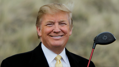 U.S. President-elect Donald Trump holds a golf club during a media event on the sand dunes of the Menie estate, the site for Trump's then-proposed golf resort, near Aberdeen, Scotland.