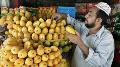 A man sells mangos in Pakistan
