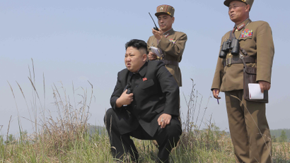 North Korean leader Kim Jong Un (C) guides the multiple-rocket launching drill of women's sub-units under KPA Unit 851, in this undated photo released by North Korea's Korean Central News Agency (KCNA) April 24, 2014.