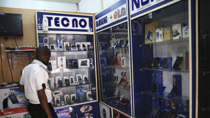A man looks at smartphones on display at a shop at Wuse II business district in Abuja