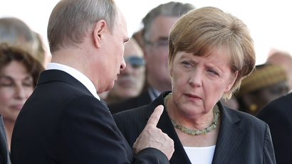 Russian President Vladimir Putin talks with German Chancellor Angela Merkel